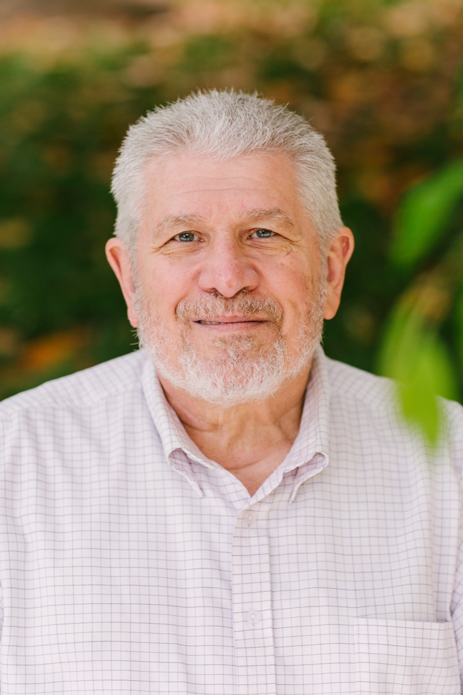 Dan Barton — white hair and beard, smiling outdoors